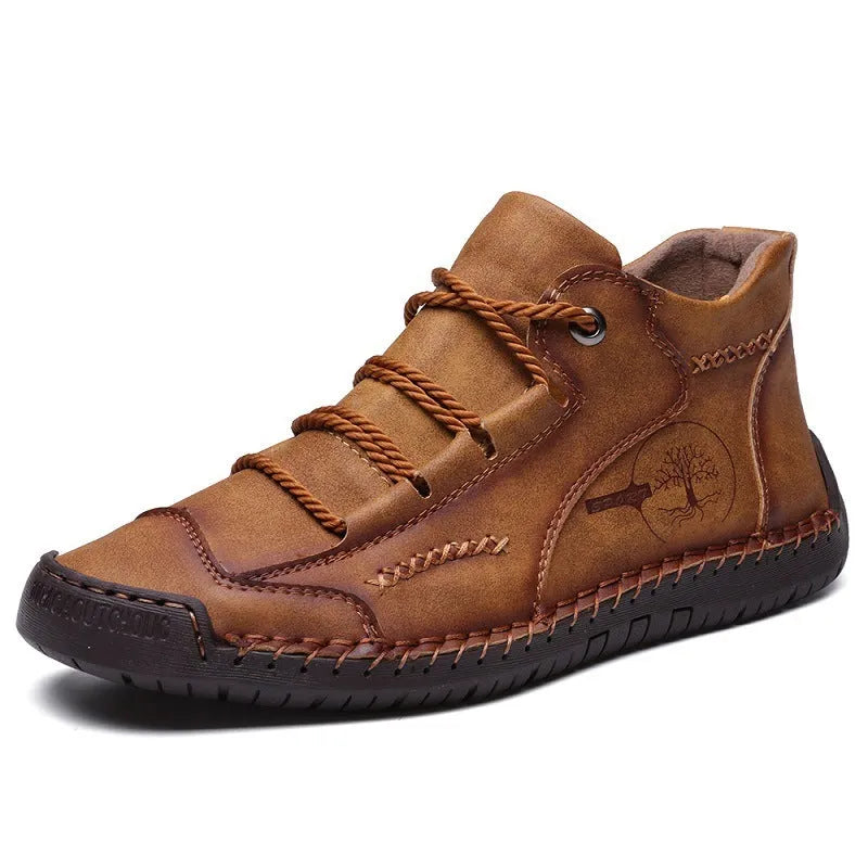 Men's brown leather high-top boots with visible stitching and flat rubber sole on a neutral background.