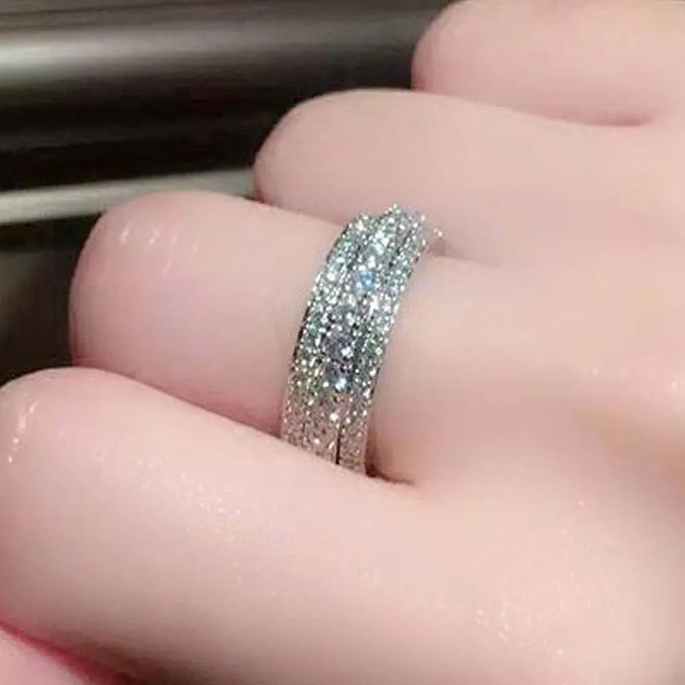 Geometric triangle ring with a zircon stone in a copper band, shown in white gold finish.