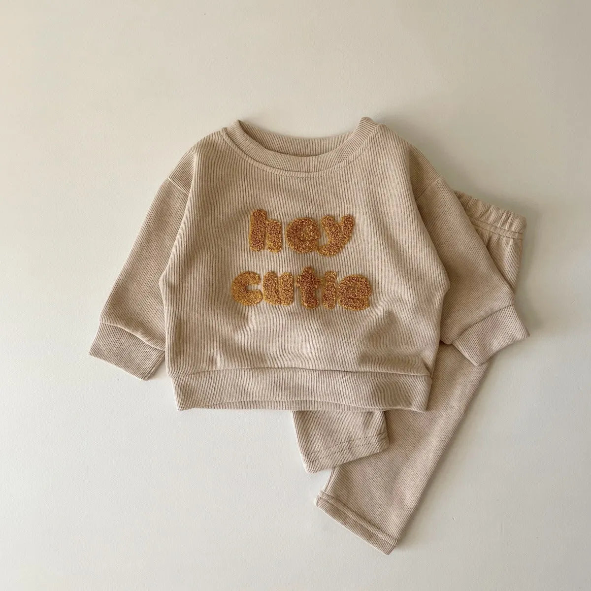 Creamy-white baby cotton two-piece suit with alphabet embroidery on long sleeve blouse and matching trousers