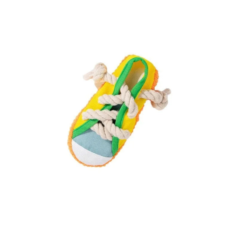 Yellow plastic dog toy shaped like a slipper with a squeaker for chewing.