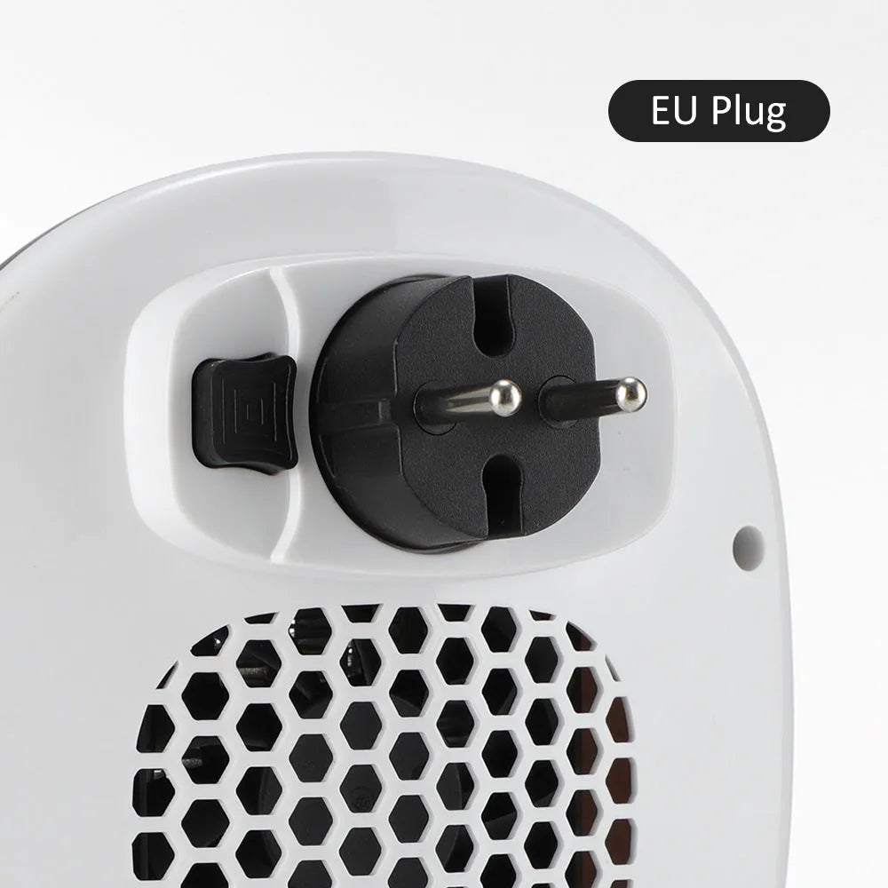 White ceramic electric heater with remote control on a table, dual voltage for EU and US plugs.