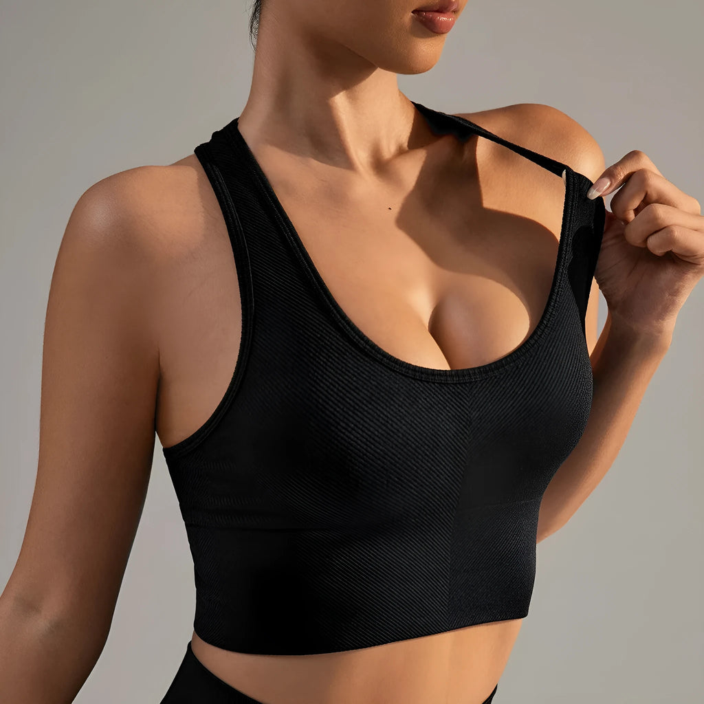 Black women's cross back sports bra with double straps and full cups for running and yoga.