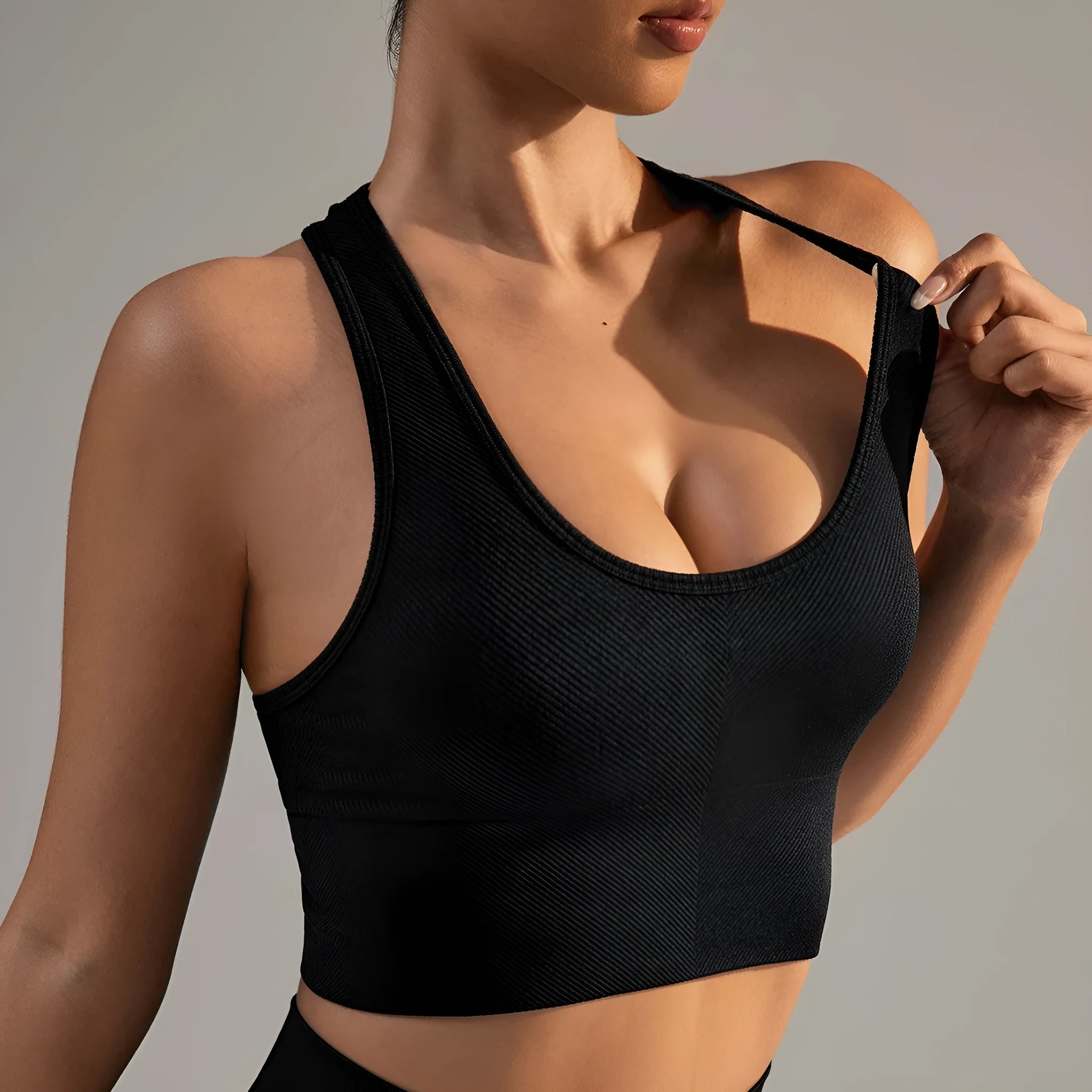 Black women's cross back sports bra with double straps and full cups for running and yoga.
