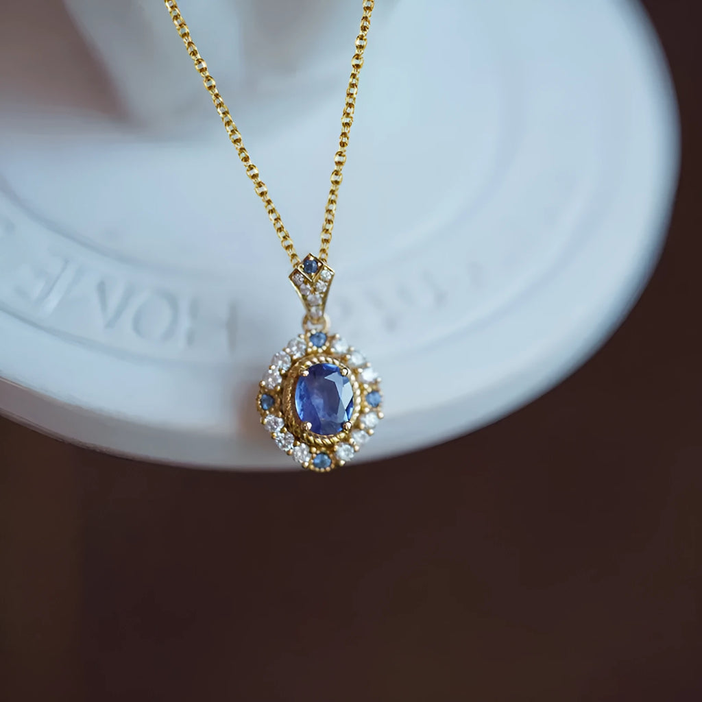 Yellow gold-tone women's necklace with adjustable box chain and a gemstone pendant featuring a central inlaid zircon.