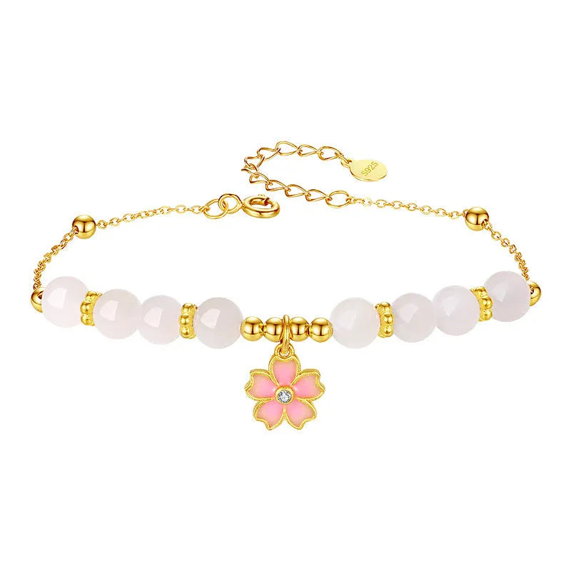 Pink women's bracelet with silver chain, Hetian jade beads, and a detailed cherry blossom flower pendant.