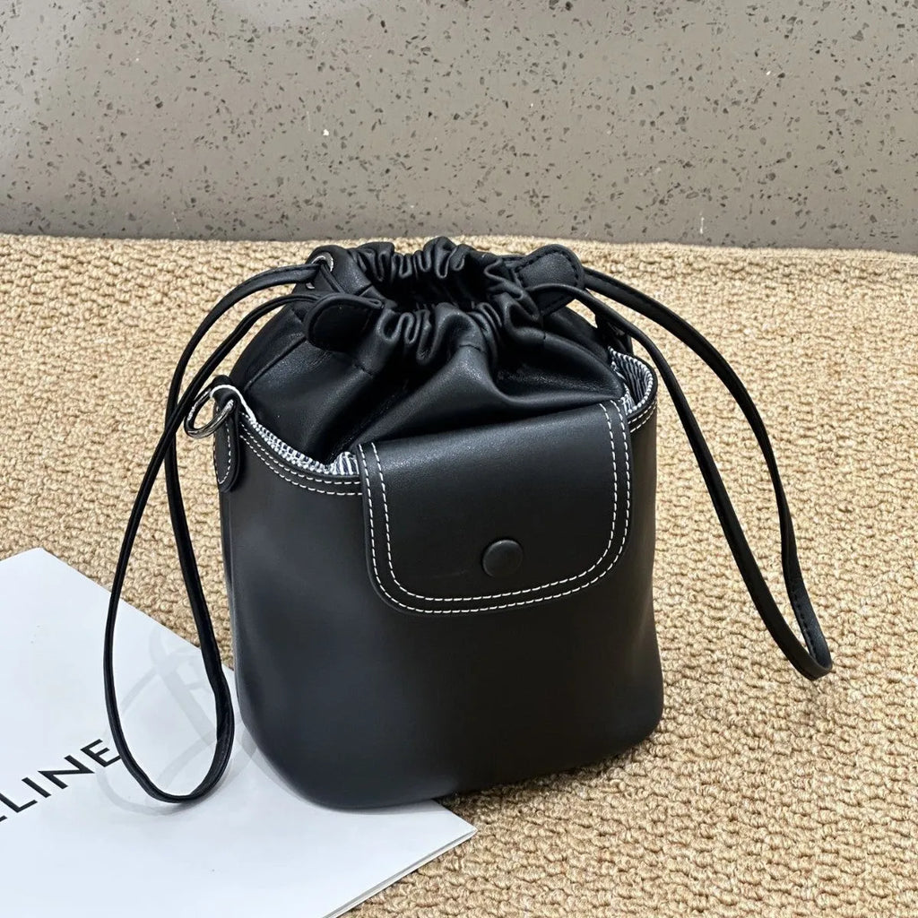 Cortex women's genuine leather bucket crossbody bag in black with drawstring closure and patchwork design, 15 x 20 x 12 cm