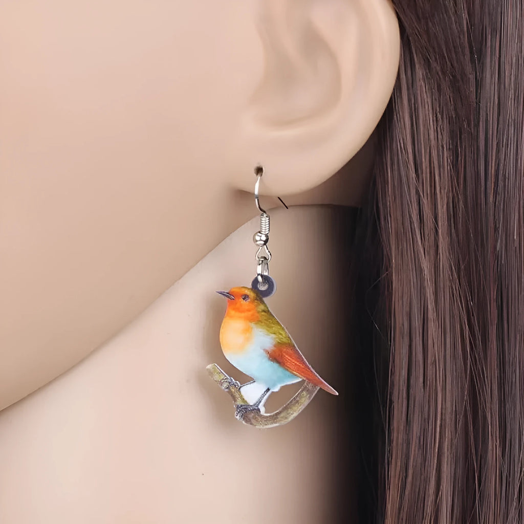 Blue Titmouse bird charm acrylic drop earrings with geometric patterns on clear pendant and silver steel posts.