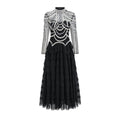 Black long sleeve women's dress with beaded decoration and a long skirt.