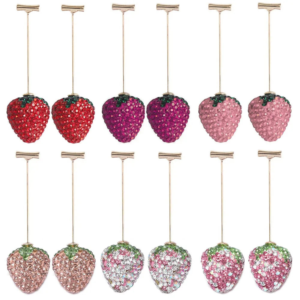 Pair of geometric strawberry stud earrings with spot drill texture in red zinc alloy, shown from front.