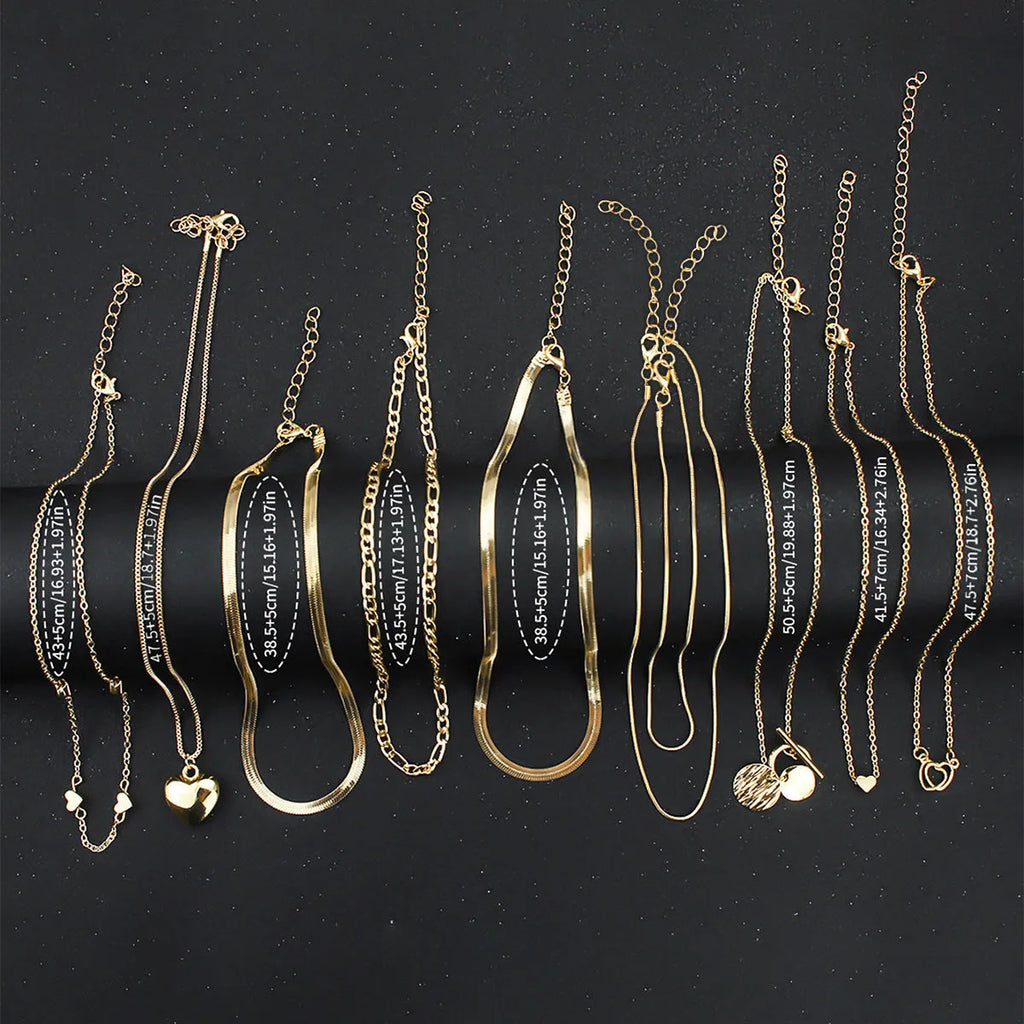 Set of ten simple gold women's necklaces with alloy pendants on snake bone chains.