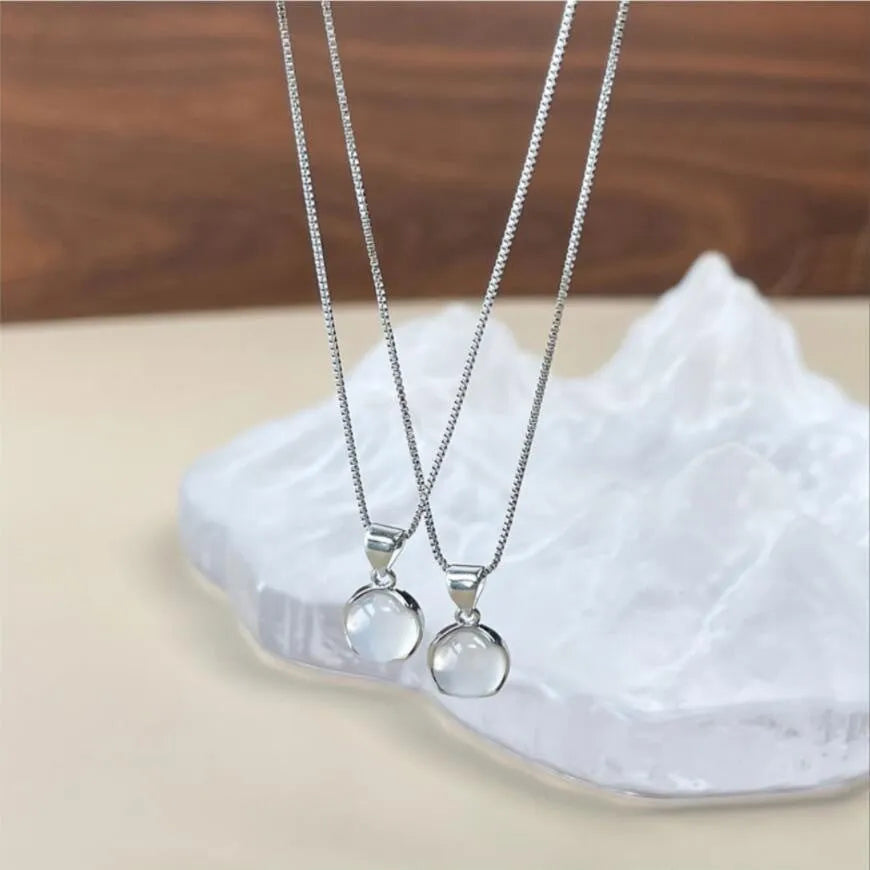 Women's oval geometric pendant necklace with artificial crystal on an adjustable silver-toned box chain.