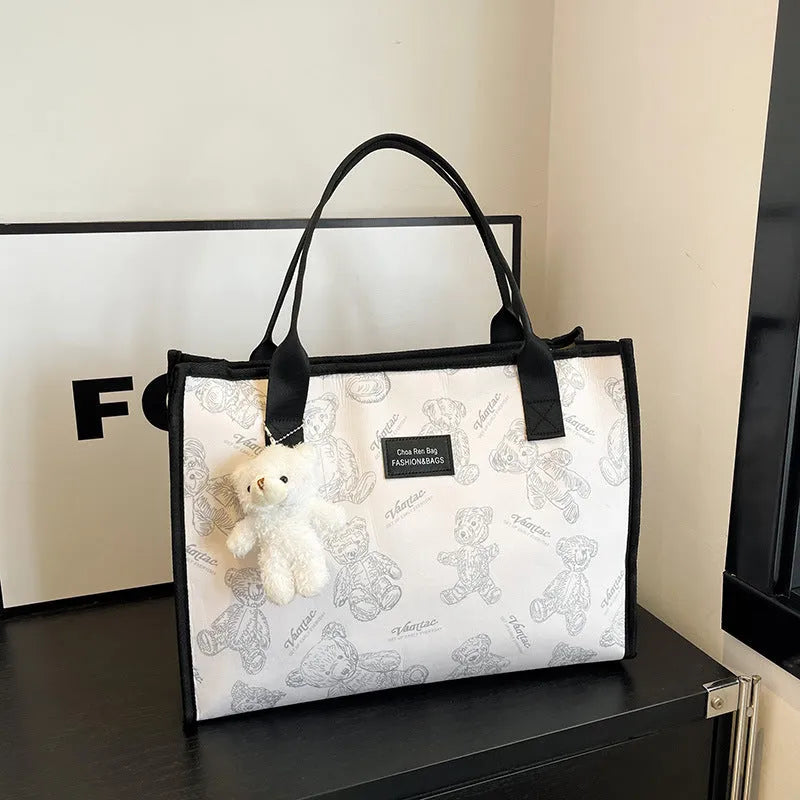Women's black canvas tote bag with rhombus pattern and horizontal square design