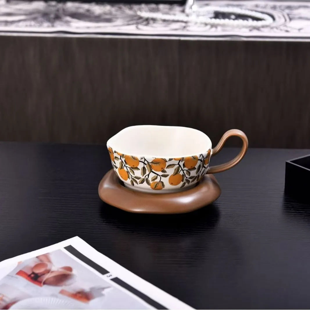 Antique style ceramic coffee cup and saucer set in retro black or orange colour.