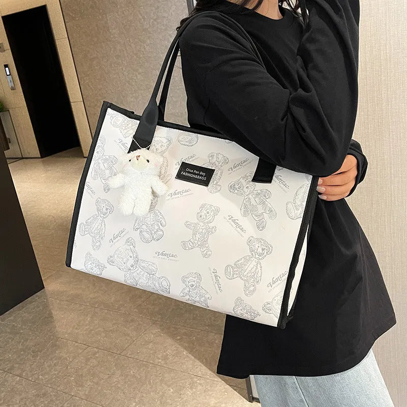 Women's black canvas tote bag with rhombus pattern and horizontal square design