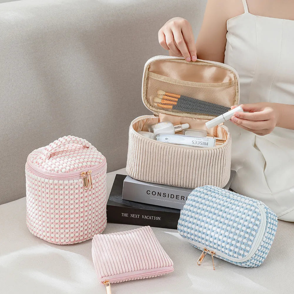 Set of four pink, khaki, and polka dot cube-shaped flannelette makeup bags for travel organisation.