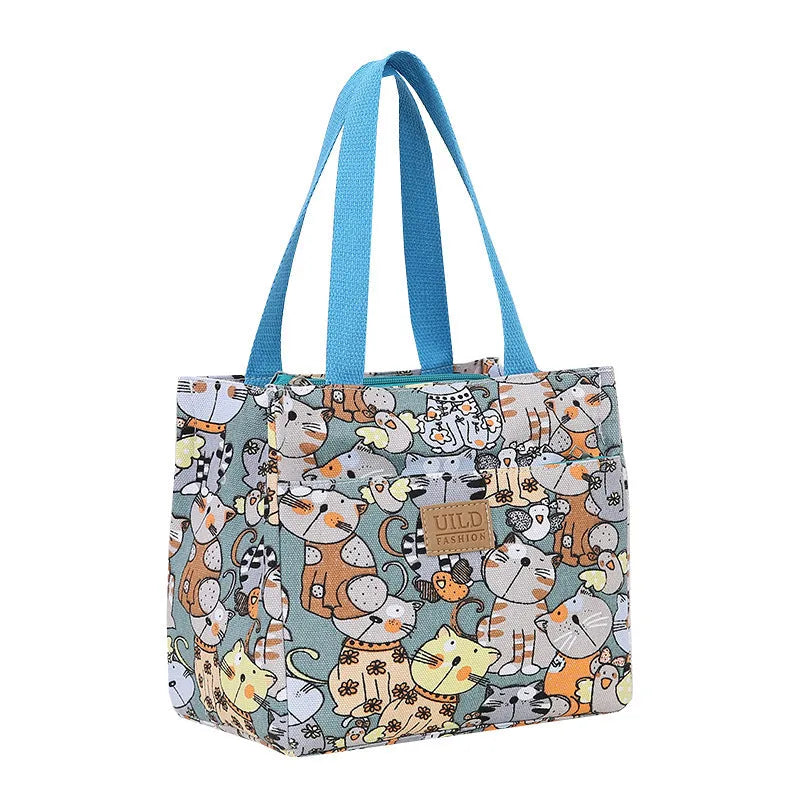 Women's printed canvas handbag with an aluminium handle in a floral design colour.
