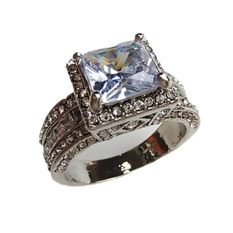 Geometric women's fashion ring with a round detail, shown in gold and white finishes on a hand.