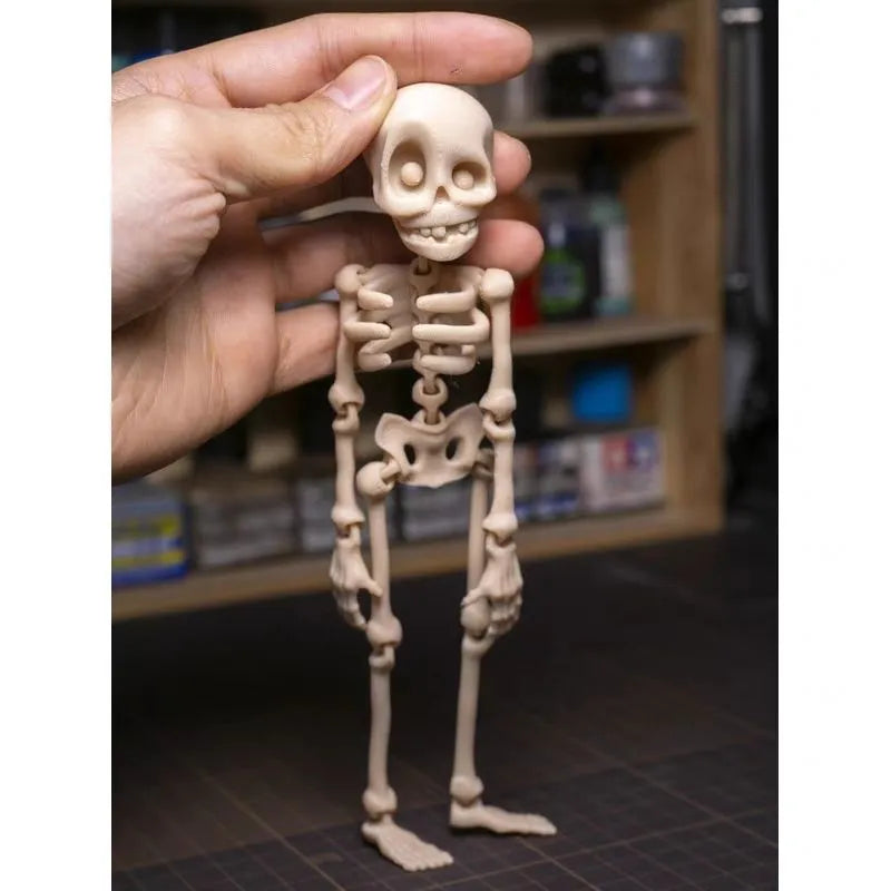 3D printed white skull refrigerator magnet on a metal surface, showing its 18cm height.