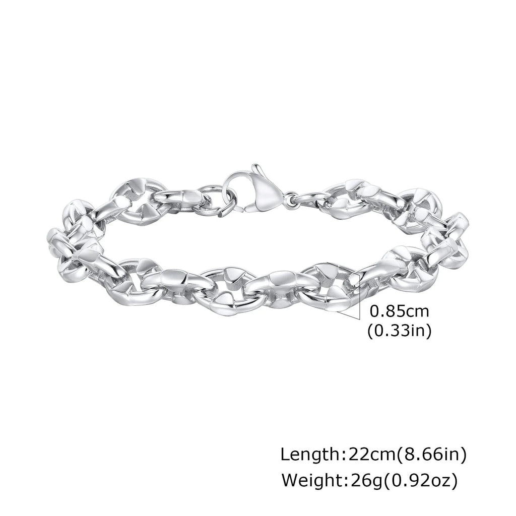 Thick stainless steel geometric link bracelet in steel colour on a wrist.