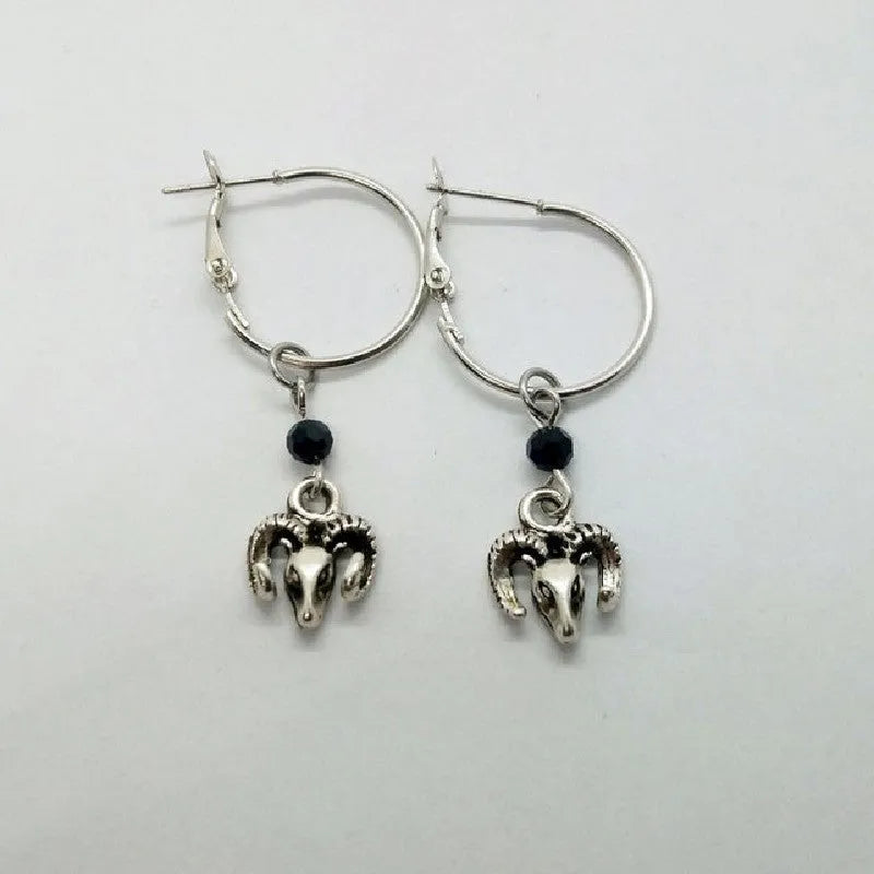 Silver round ring earrings with a Tibetan Antelope design motif.