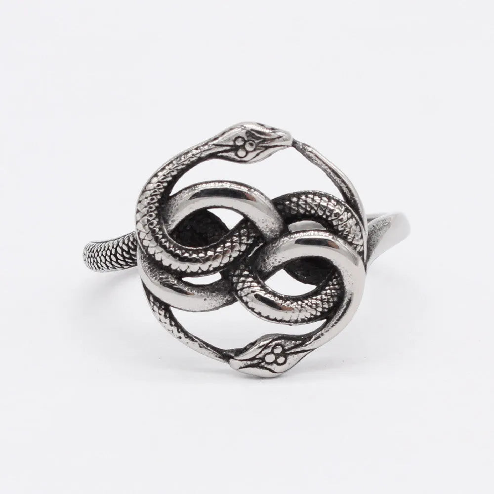 Close-up of a retro-style titanium steel double snake ring in a steel colour on a hand.