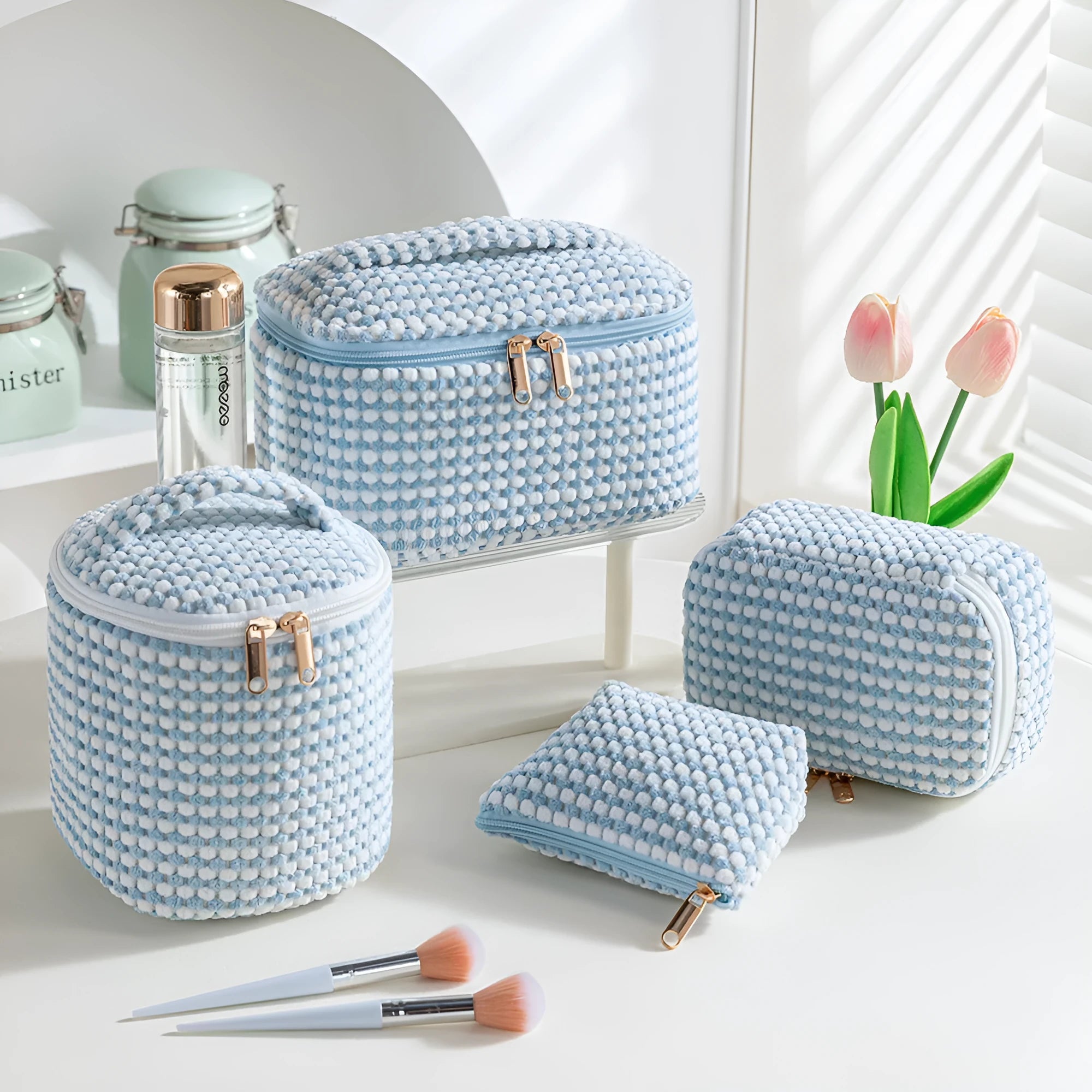 Set of four pink, khaki, and polka dot cube-shaped flannelette makeup bags for travel organisation.