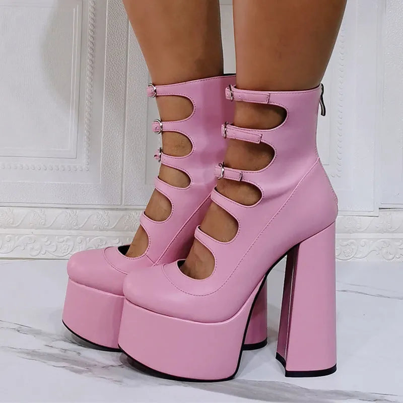 Black patent leather women's platform high heel boots with a serpentine buckle strap and round toe.