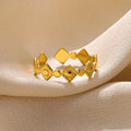 Geometric gold titanium steel ring for women on a white background.