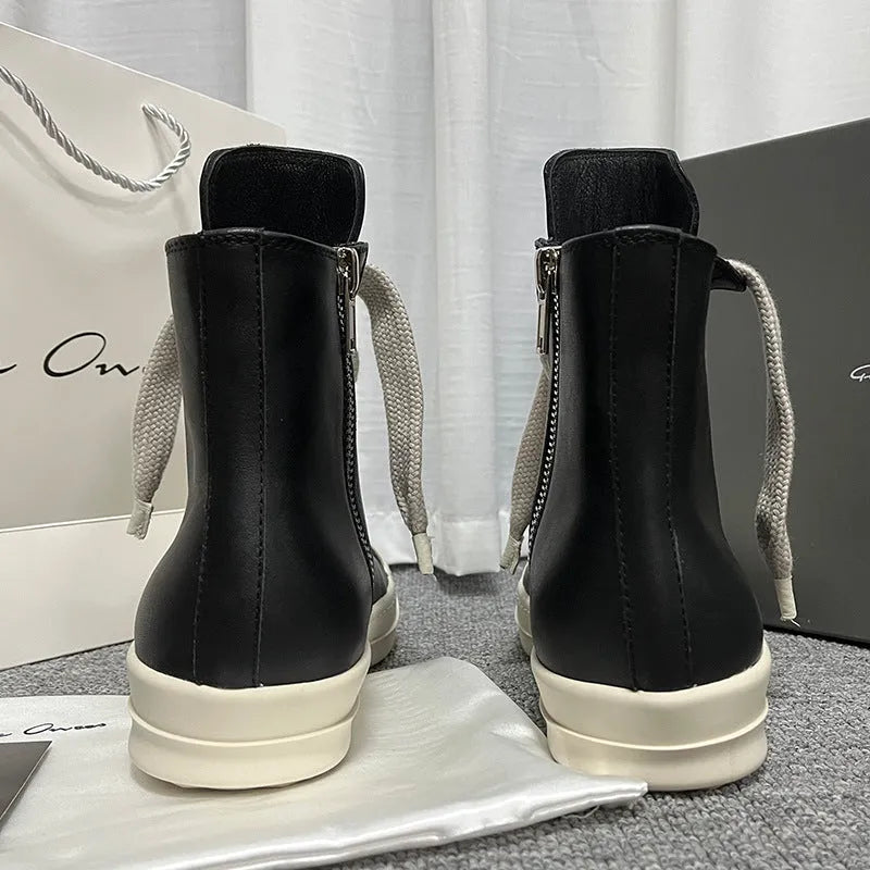 Black high-top leather boots with side zipper and round toe on a white background.