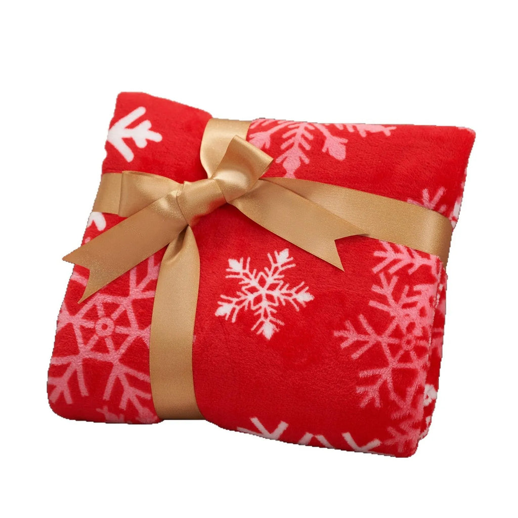 Soft flannel plush Christmas blanket in a choice of colours and multiple sizes on a sofa.