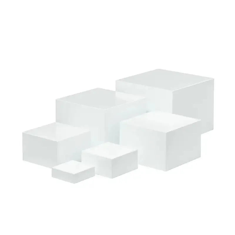 White plastic stacking cube dessert display stand set arranged in a pyramid for cakes and cupcakes.