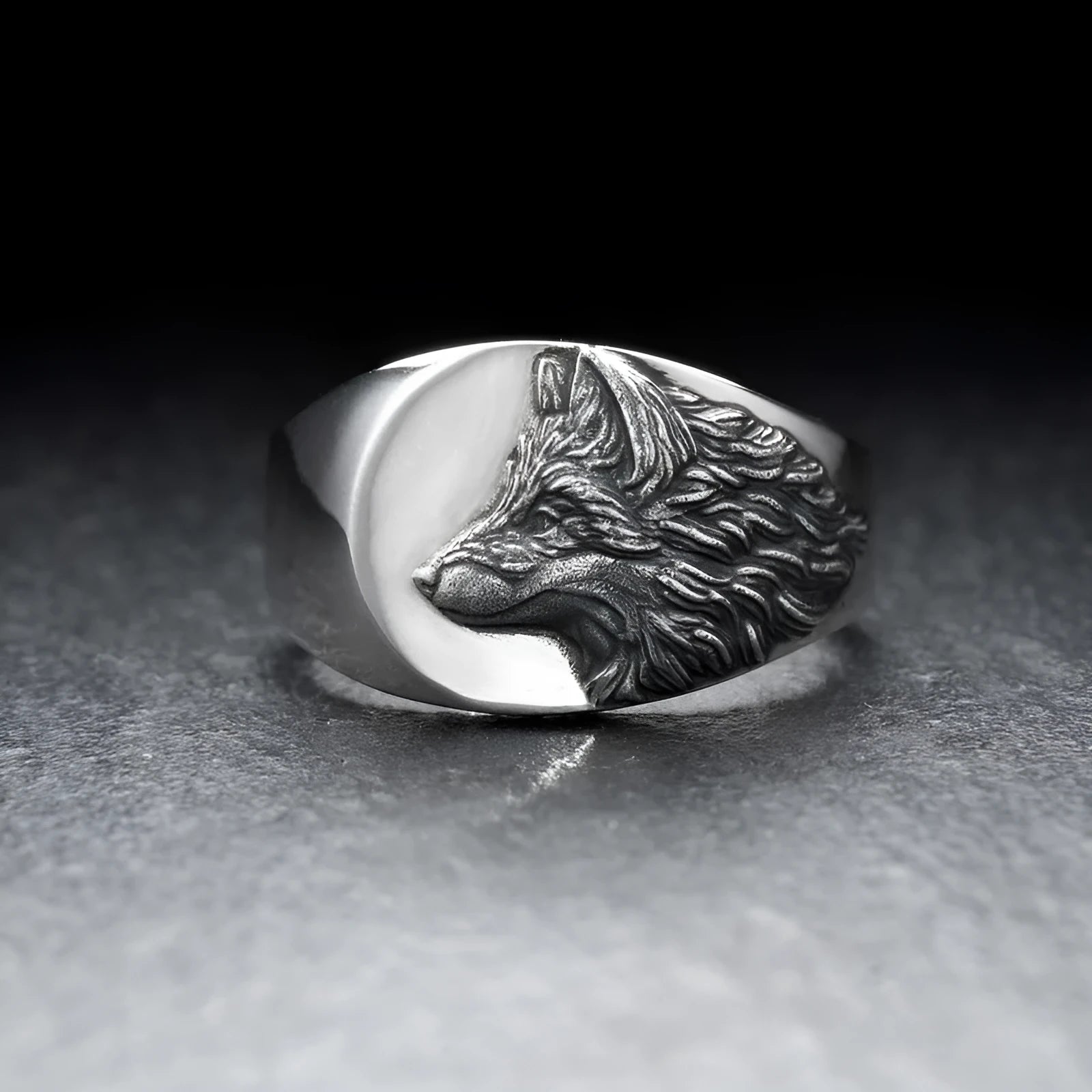 Men's silver geometric wolf head ring made from alloy on a grey background.