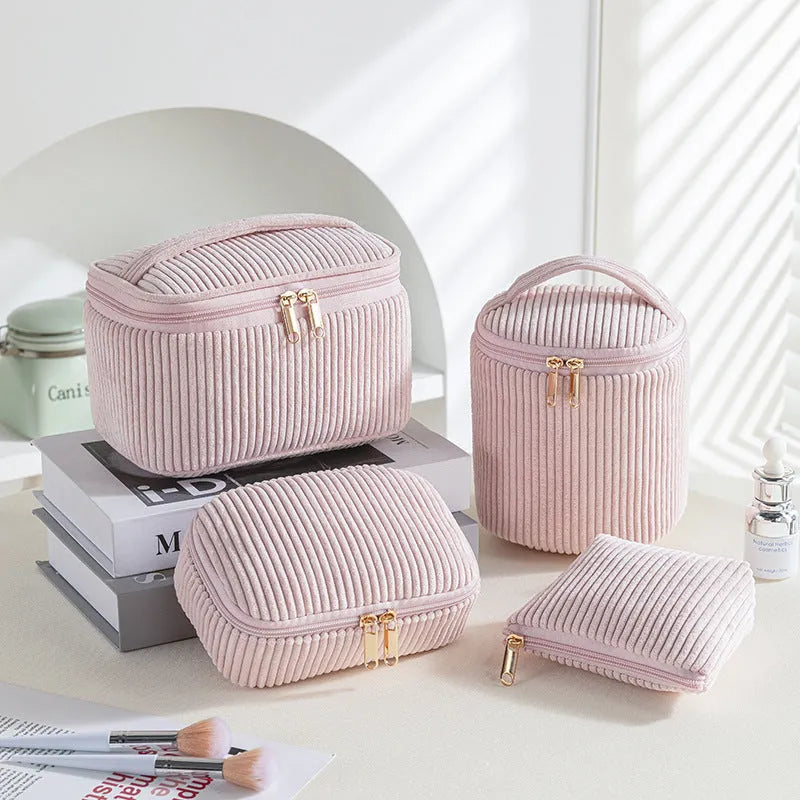 Four cube-shaped flannelette makeup bags in a set, showing pink dots and solid colour options.