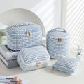 Set of four pink, khaki, and polka dot cube-shaped flannelette makeup bags for travel organisation.
