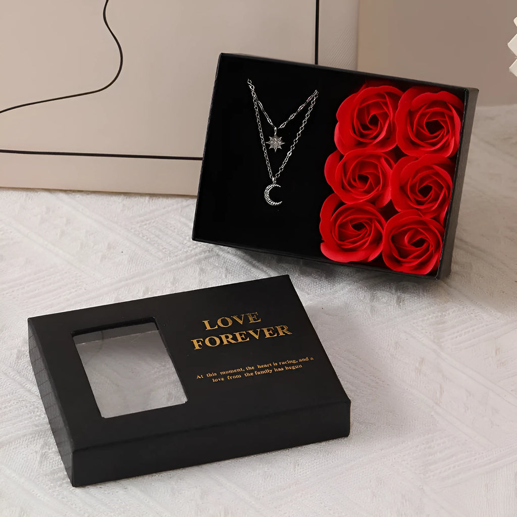 Red Korean-style gift box open to show six pink soap flowers, with a matching red handbag beside it.