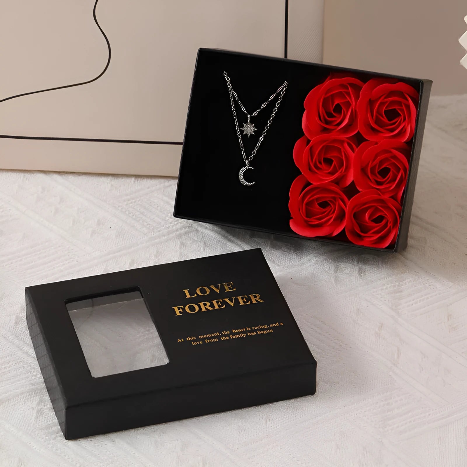 Red Korean-style gift box open to show six pink soap flowers, with a matching red handbag beside it.