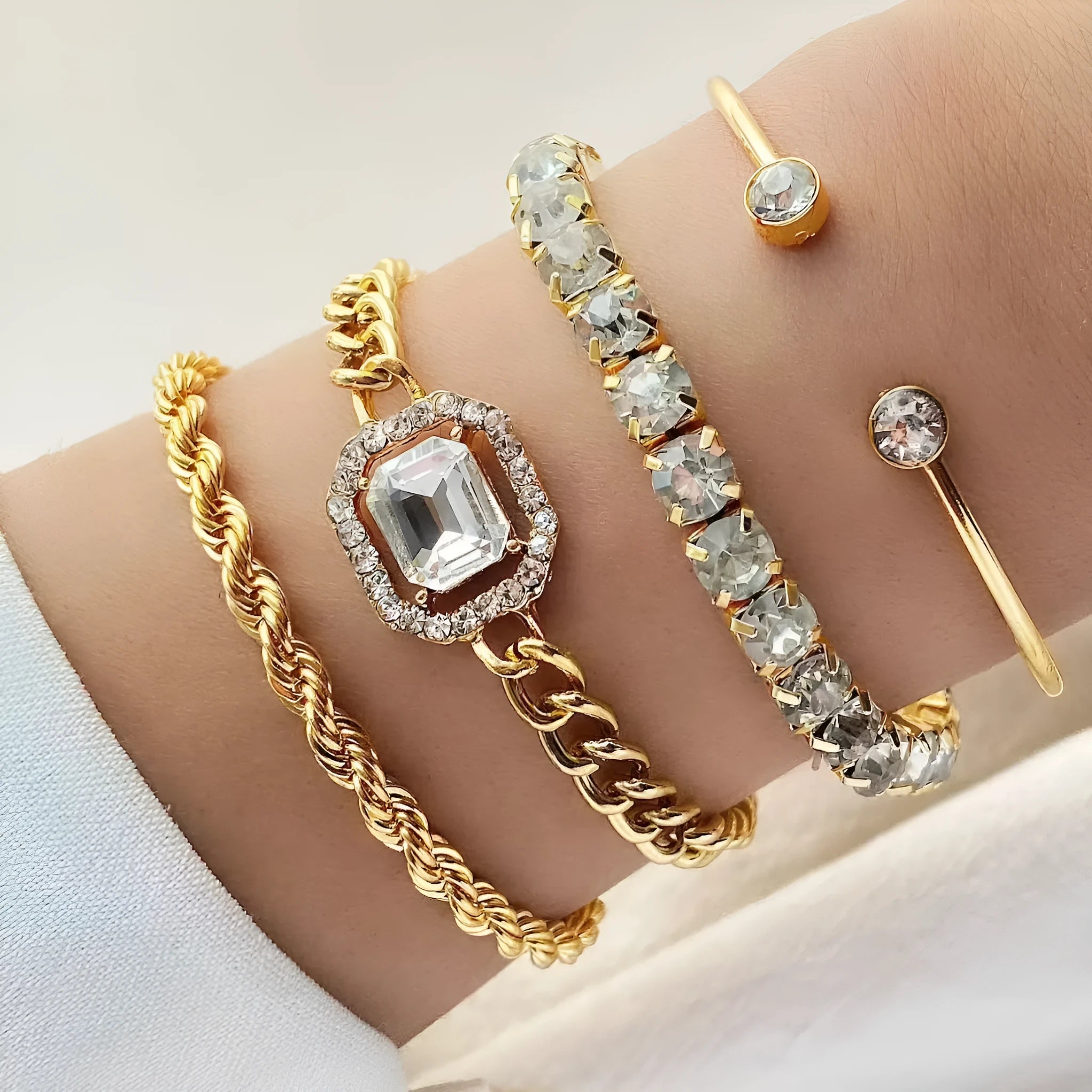 Retro geometric alloy bracelet four-piece set with square diamond details in gold and silver colours.