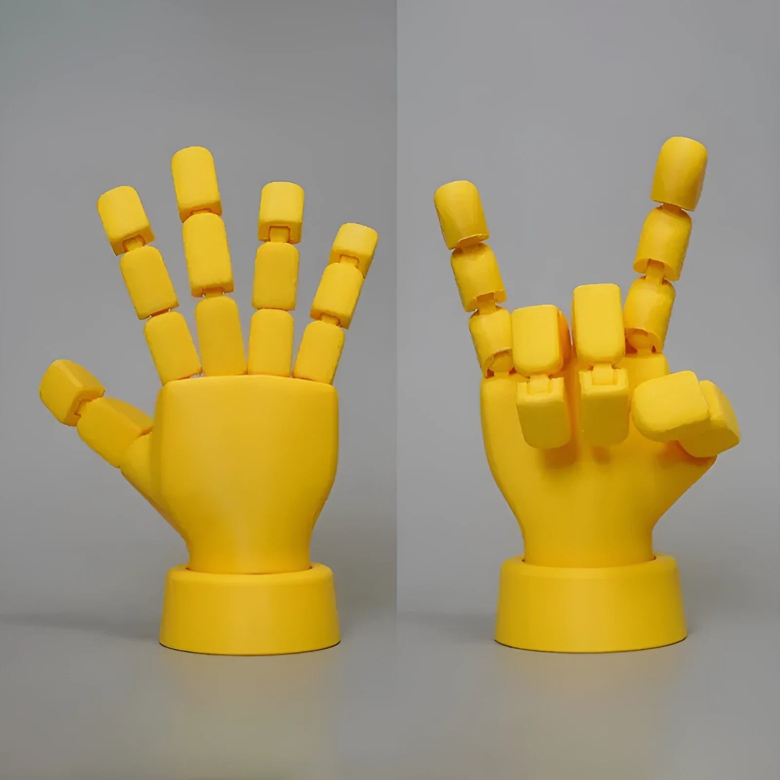 Yellow movable joint hand prop ornament with articulated fingers on a neutral background.
