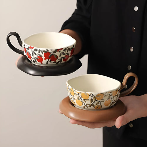 Antique style ceramic coffee cup and saucer set in retro black or orange colour.