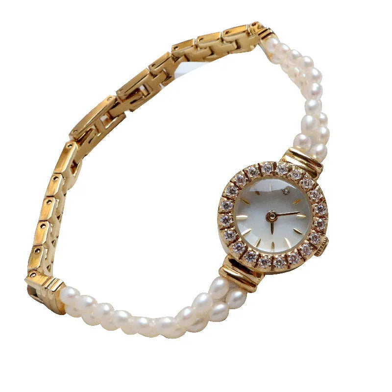 Women's light gold bracelet watch with freshwater pearls, showing 18mm round dial and stainless steel strap.