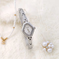 Women's gold or silver fashion bracelet watch with 18mm dial and chain strap.
