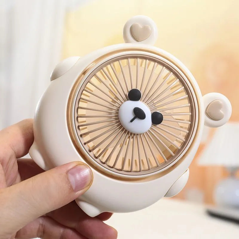 Cute dog-themed USB desktop electric fan in apricot puppy colour on a wooden desk.