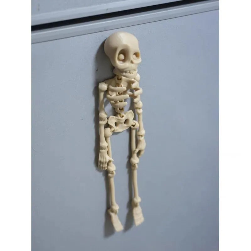 3D printed white skull refrigerator magnet on a metal surface, showing its 18cm height.