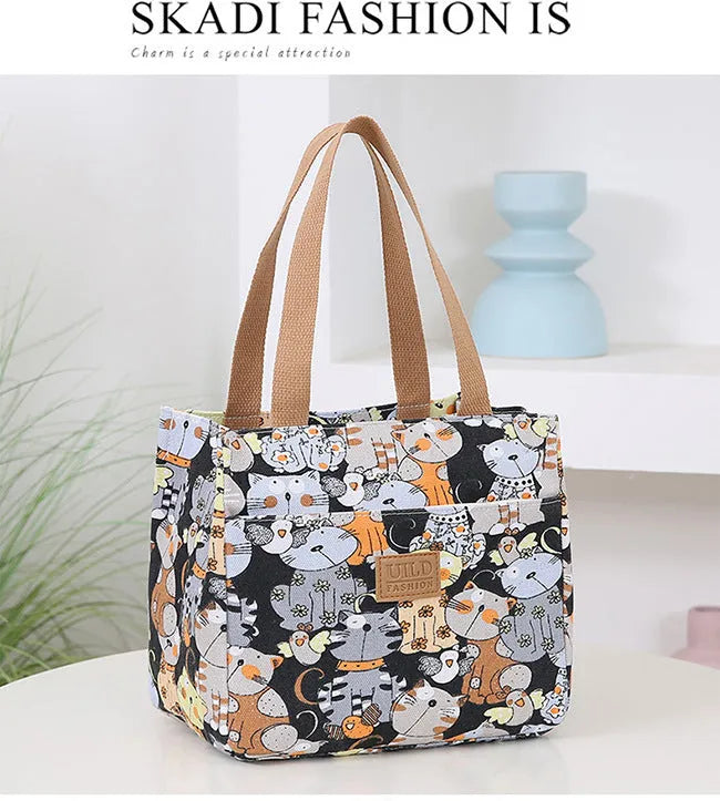 Women's printed canvas handbag with an aluminium handle in a floral design colour.