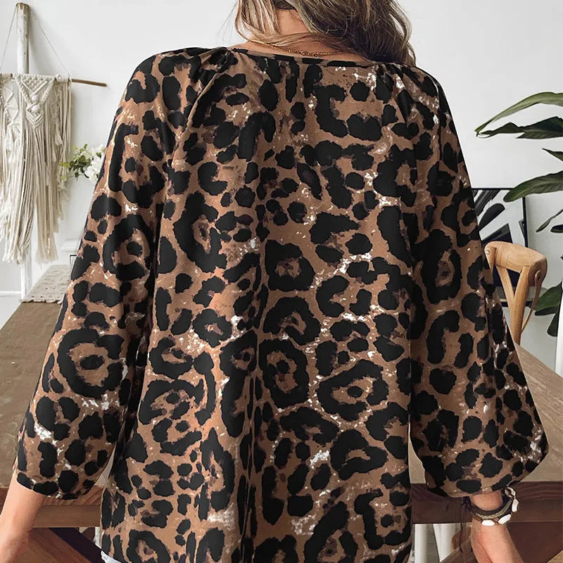 Women's multicolour leopard print V-neck pullover top with half sleeves and pleated detail.