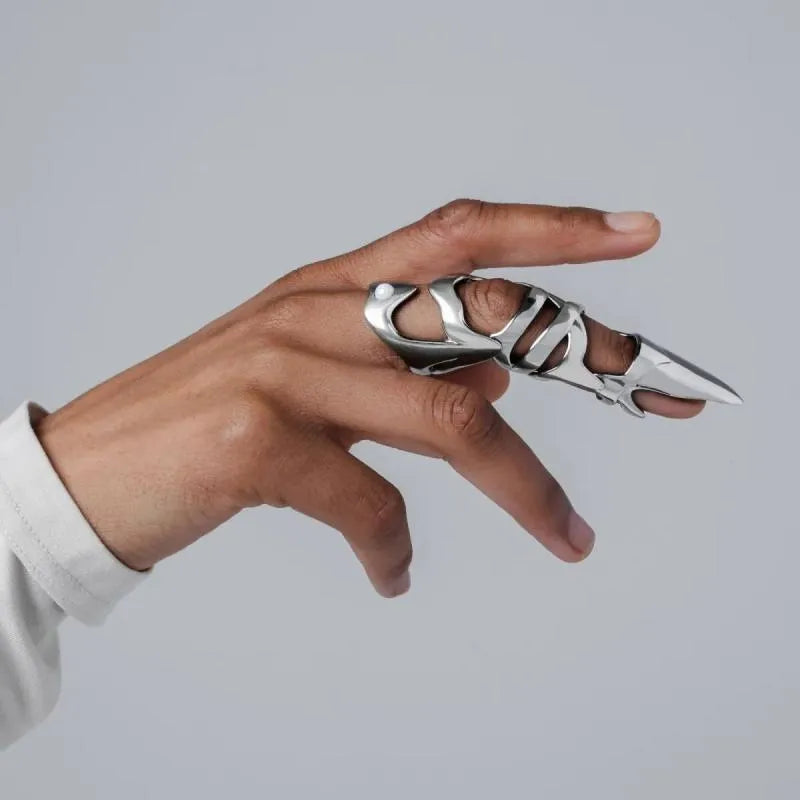 Silver metal punk armour finger stall ring on a finger.