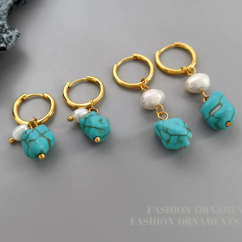 A pair of geometric copper clip-on earrings featuring irregular blue-green turquoise stones and white cultured pearls.
