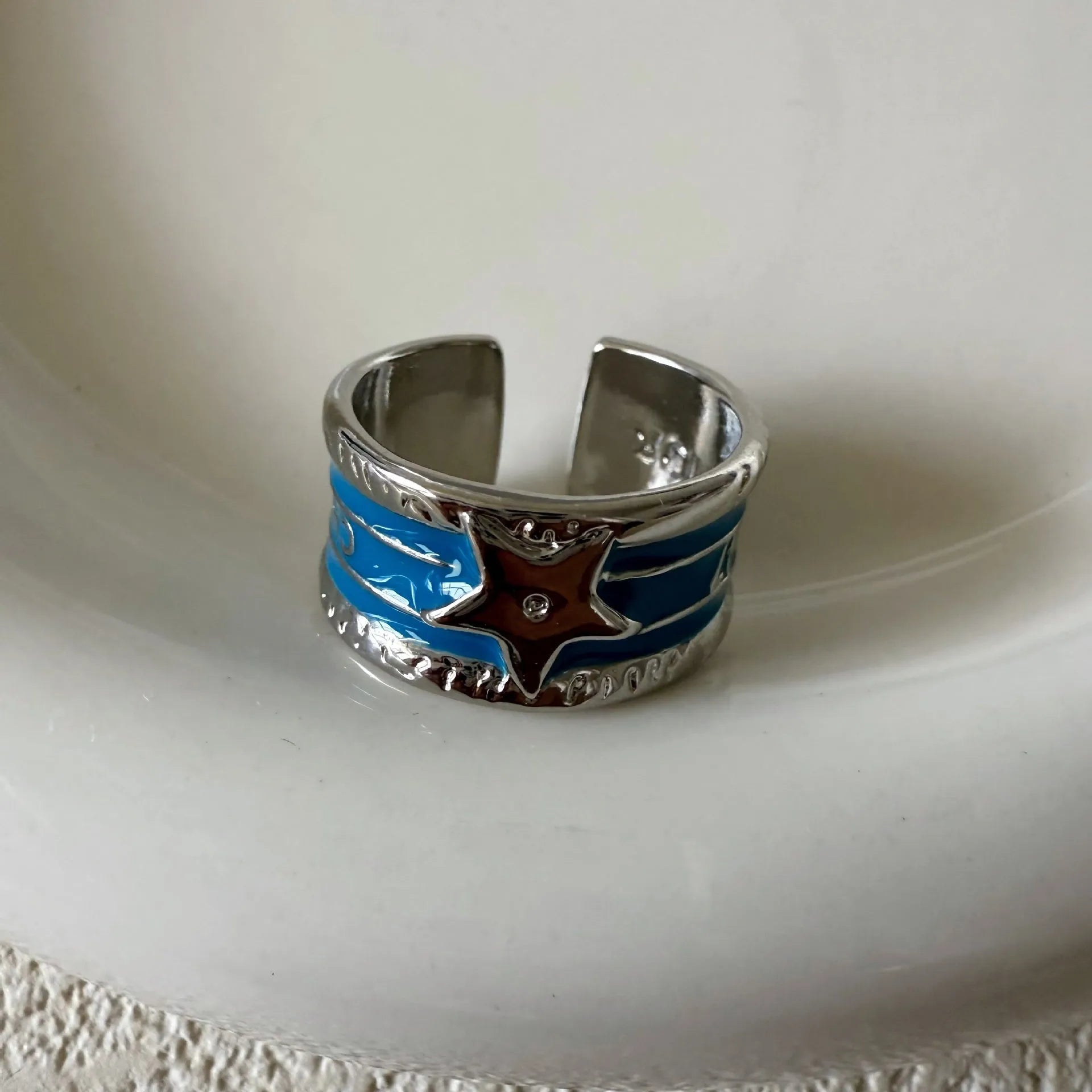 Geometric adjustable copper ring with a distressed XINGX drop oil pattern in multiple colour options.
