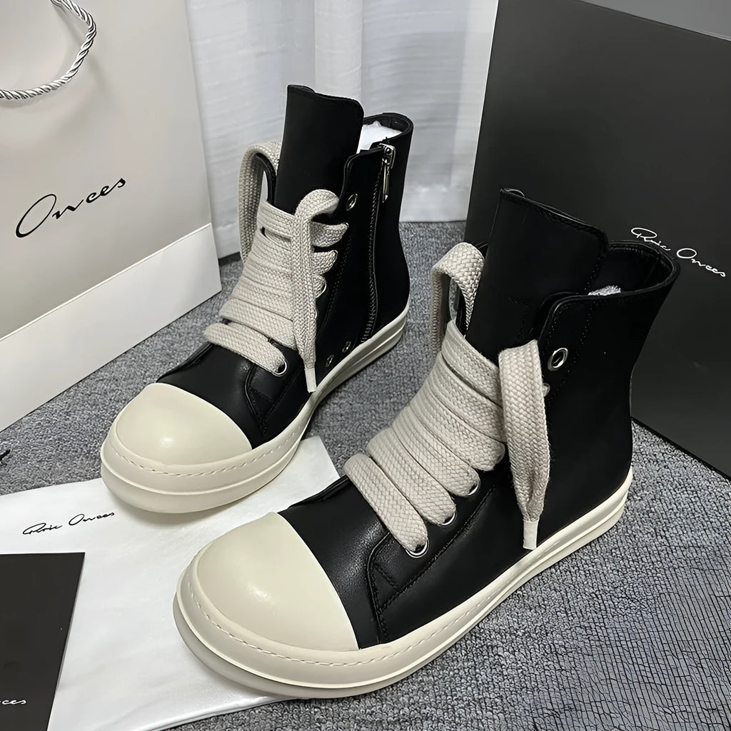 Black high-top leather boots with side zipper and round toe on a white background.