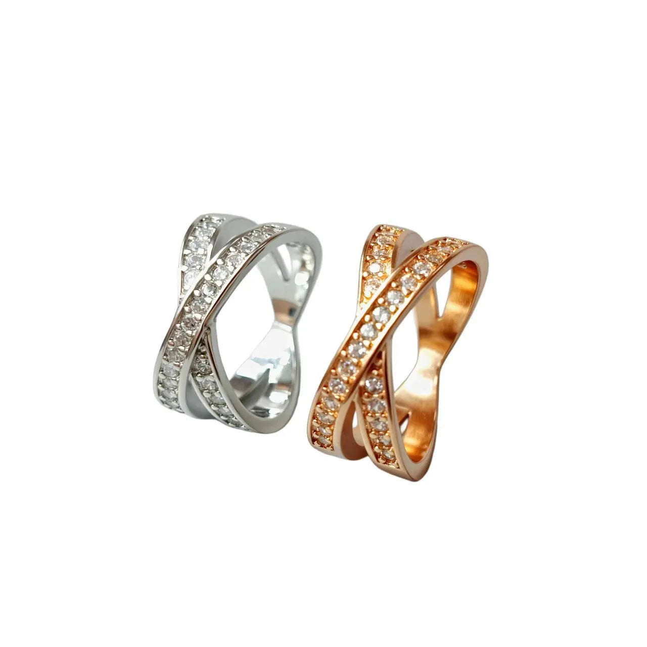 A silver or rose gold metal ring with a cross design and small micro-inlaid zircon stones.
